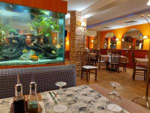 a restaurant with a fish tank in the middle of a table at Eleganza Family Hotel in Sofia