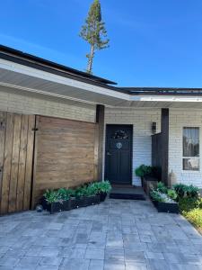 a house with a black door and some plants at La Mia Casa II in Sarasota