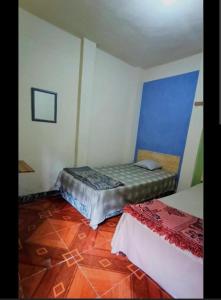 a bedroom with two beds in a room at Pacífico Jaguar Antigua in Antigua Guatemala