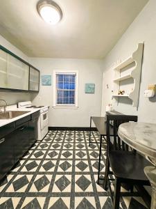 a kitchen with a black and white checkered floor at Peaceful Location Close to University & Hospitals in Lexington