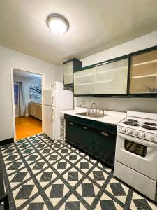 a kitchen with a stove and a white refrigerator at Peaceful Location Close to University & Hospitals in Lexington