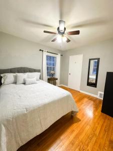 a bedroom with a bed and a ceiling fan at Peaceful Location Close to University & Hospitals in Lexington +12 photos