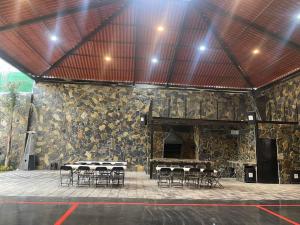 a group of tables and chairs in a stone building at Casa las palmerasmeras in Chalco de Díaz Covarrubias
