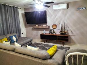 a living room with two couches and a flat screen tv at central and tourist residence in Ciudad Madero