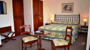 Un pat sau paturi într-o cameră la Hotel Salta