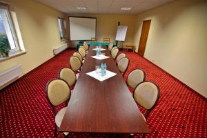 a conference room with a long table and chairs at Hotel Milord in Pultusk