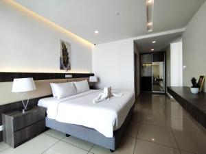 a bedroom with a large white bed in a room at Genting FoggyColdInn1R1B AT Ion Delemen in Genting Highlands +48 photos
