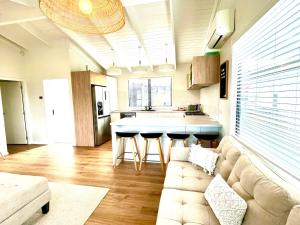 a living room with a couch and a kitchen at The Lake Haus in Mangakino
