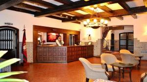 a man is standing at a counter in a kitchen at Hotel Salta in Salta