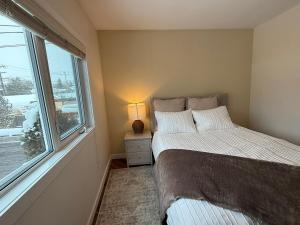 a bedroom with two beds next to a window at 2Bed Bright & Stylish Ritchie Urban Retreat in Edmonton