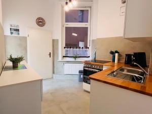 a kitchen with a sink and a stove at Ferienwohnung Reeperbahn Ecke Große Freiheit in Hamburg