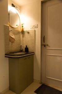 a bathroom with a sink and a mirror next to a door at YOLO villa in Pirangut +13 photos