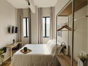 桑托斯Apê Santos Praia do Gonzaga的带床、书桌和窗户的卧室