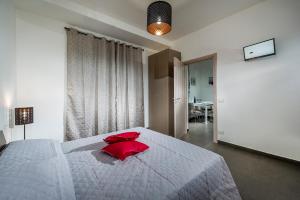 カステッランマーレ・デル・ゴルフォにあるCasetta Venereのベッドルーム1室(赤い枕が付いた大型ベッド1台付)