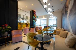 a restaurant with tables and chairs in a room at Gate Twenty Two Boutique Hotel in Nicosia