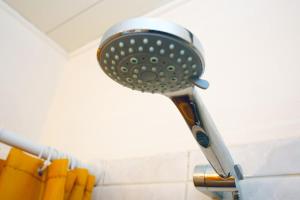 a hairdryer hanging on a wall next to a traffic light at Cozy stash between Paris & Disney in Neuilly-Plaisance