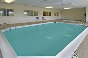 a large swimming pool with chairs in a building at Ramada Limited - Mount Sterling in Mount Sterling