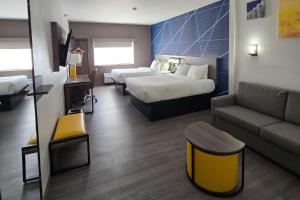 a hotel room with a bed and a couch at Comfort Suites Terre Haute University Area in Terre Haute +19 photos