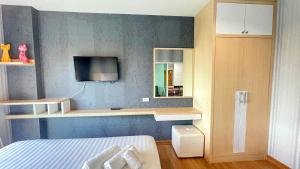 Un dormitorio con una cama y un televisor en la pared. en spacious and modern Apartment in Ao Nang, en Ban Khlong Haeng 16 fotos más