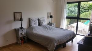 En eller flere senge i et værelse på Maison 24H du Mans pour Chambres