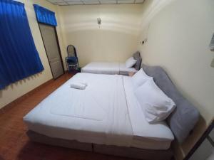 Postel nebo postele na pokoji v ubytování Cameron Homestay Betong คาเมร่อนโฮมสเตย์เบตง