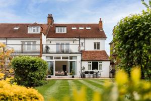 an exterior view of a house with a yard at Luxury three bedroom serviced apartment - Springfield in Claygate