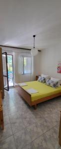 a bedroom with a large yellow bed in a room at Residence Paula in Jadranovo