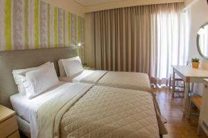 Postel nebo postele na pokoji v ubytování Hotel Pitsakis