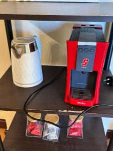 a red juice carton with a laptop on a shelf at Beach view in King Abdullah Economic City