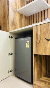 a refrigerator in a room with wooden walls at Leisure Homes in Lucknow