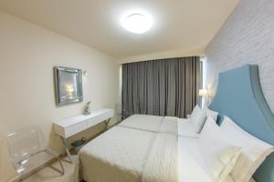 Postel nebo postele na pokoji v ubytování Hotel Pitsakis