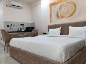 a bedroom with a large bed and a desk at Leisure Homes in Lucknow