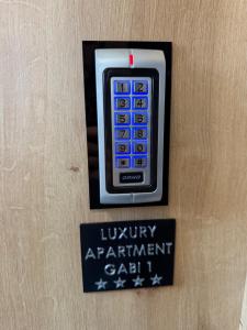 a remote control on a wall with a sign at Luxury apartment Gabi 1 in Slavonski Brod