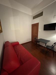 a living room with a red couch and a table at Milion's house in Salerno