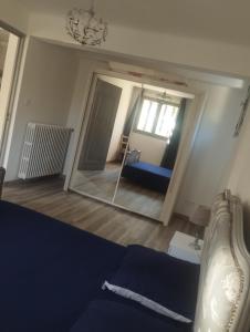 a bedroom with a mirror and a couch in a room at les oliviers in Carpentras