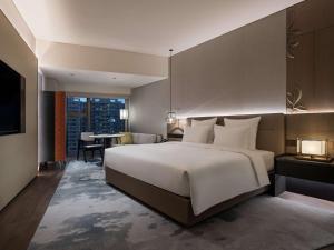 Voodi või voodid majutusasutuse Pullman Quanzhou Shuitou toas