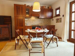 a kitchen with a table and chairs in a room at Hostdomus - Castle Apartments in Bessé-Bas