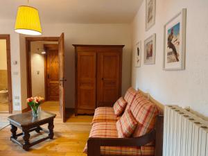 a living room with a couch and a table at Hostdomus - Castle Apartments in Bessé-Bas