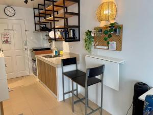a kitchen with a counter and a bar with a stool at Unit 26 SeaView Studio in Dumaguete