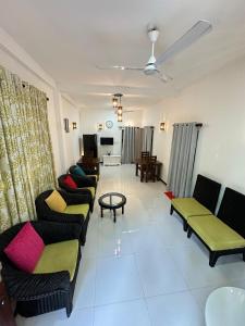a living room with couches and a table at Seagate Villa in Bentota