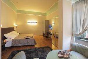 Postel nebo postele na pokoji v ubytování Grand Hotel Nizza Et Suisse