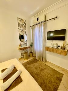 a living room with a bed and a flat screen tv at Appartement B living in Agadir