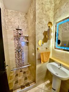 a bathroom with a shower and a sink at Appartement B living in Agadir +5 photos