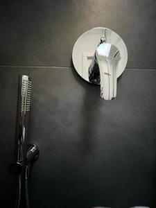 a bathroom with a hair dryer and a mirror at Mood's Home BLQ in Bologna