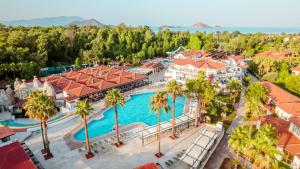 an aerial view of a resort with a pool and palm trees at Lykia Botanika Beach Fun & Club - All Inclusive in Fethiye