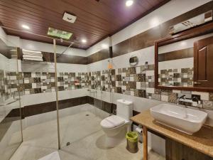 a bathroom with a toilet and a sink and a shower at KAMNA HILL RESORT a Boutique cottages in Shimla +137 photos