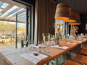 a long wooden table with glasses and napkins at Fiddle + Bow Hotel in Doolin