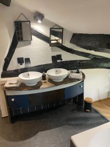 a bathroom with two sinks on a counter at Ferme Fleurie in Bergesserin +45 photos