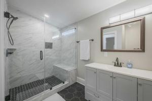a bathroom with a shower and a sink and a mirror at Five Points Mill House in Athens