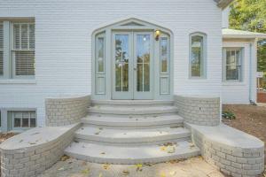 a front door of a white house with stairs at Five Points Mill House in Athens